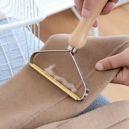 Rasoir à peluches manuel avec manche en bois utilisé sur un tissu beige pour enlever les bouloches